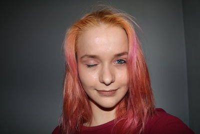 Portrait of smiling woman against black background