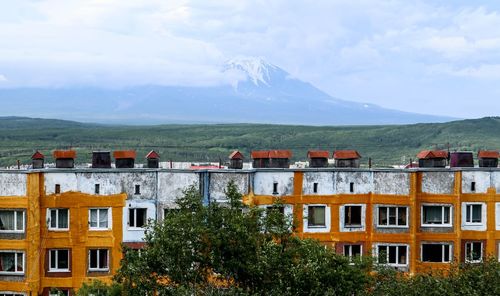 High angle view of buildings and mountains against sky