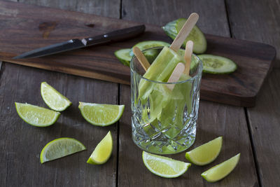 Close-up of flavored ice with lemon slices on wooden table