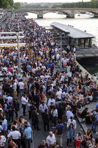 High angle view of crowd on street by seine river