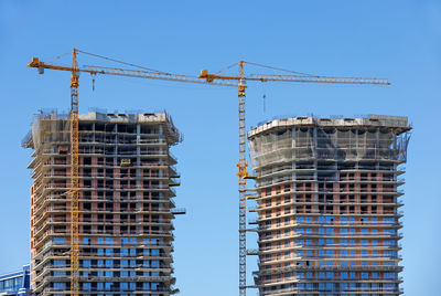 Low angle view of skyscrapers against clear sky