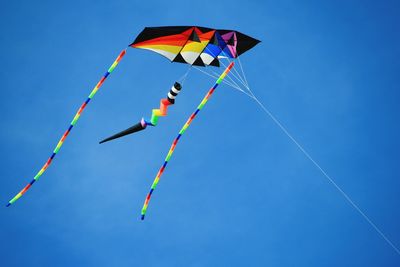 Low angle view of colorful kite flying in sky