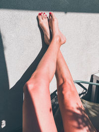 Low section of woman relaxing on floor