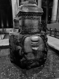 Close-up of buddha statue against building