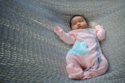High angle view of baby girl sleeping on hammock