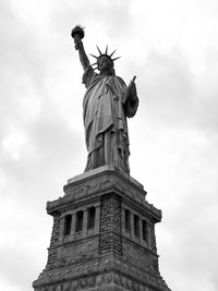 Low angle view of statue of liberty against sky