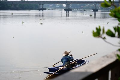 Woman sitting in boat on lake