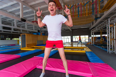 Full length portrait of happy man standing on the floor