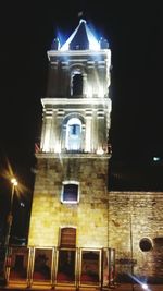 Low angle view of bell tower at night