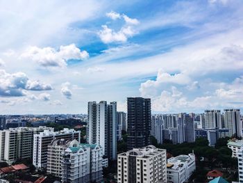 View of cityscape against cloudy sky