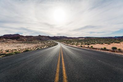 Empty road along countryside landscape