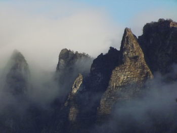 Scenic view of sea and mountains against sky