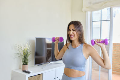 Young woman exercising in gym