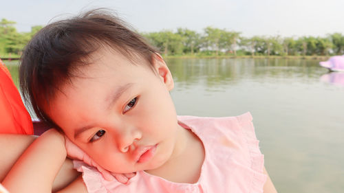 Portrait of cute girl looking at lake