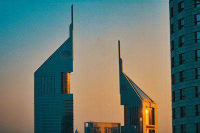 Low angle view of buildings against sky during sunset