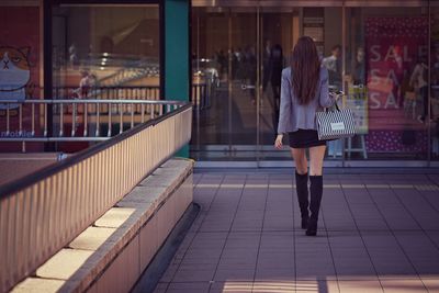 Rear view of woman walking at store