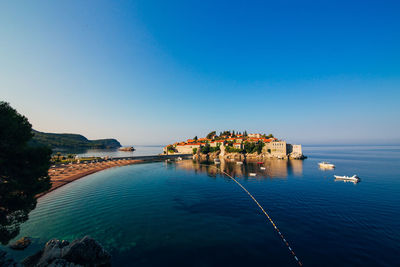 Scenic view of sea against clear blue sky