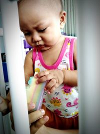 Cute girl holding baby at home