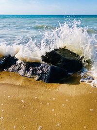 Scenic view of sea waves splashing on shore