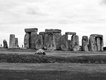  stonehenge on field against sky