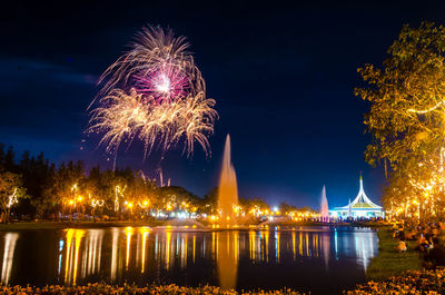 Firework display over river at night