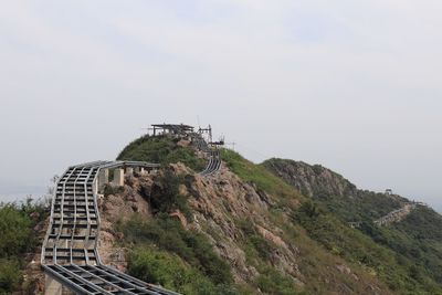 Low angle view of castle on mountain against sky