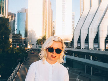 Portrait of woman against skyscrapers