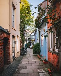 Footpath amidst buildings in city