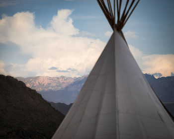 Close-up of tent against mountains and sky