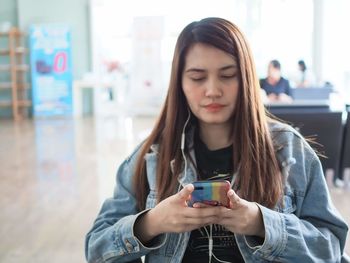 Portrait of teenage girl using mobile phone
