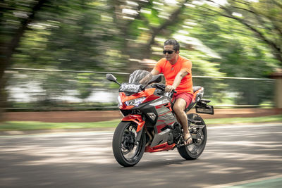 Man riding motorcycle on road