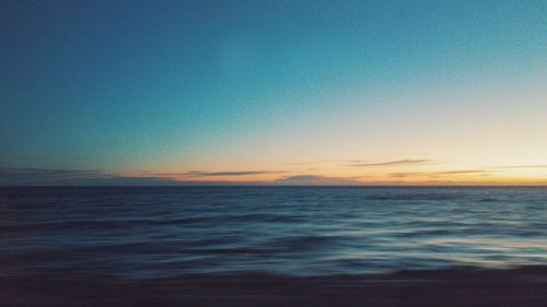 Scenic view of sea against clear sky at sunset