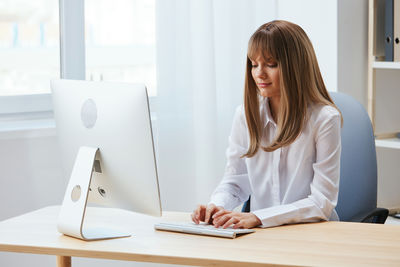 Midsection of businesswoman working at office