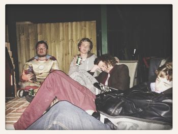 Portrait of happy friends sitting on table