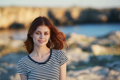 Portrait of smiling young woman standing outdoors