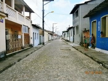 Empty alley amidst buildings in city