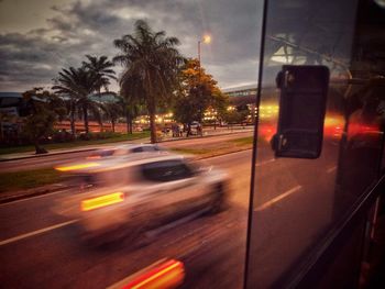 Cars on street in city at dusk