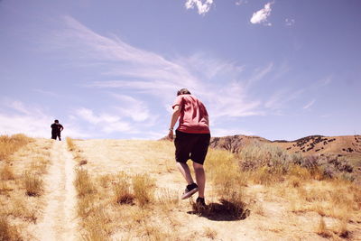 Rear view of woman standing on landscape