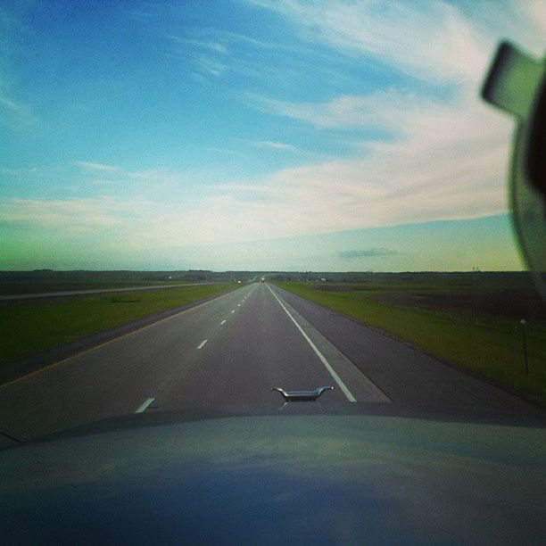 transportation, road, the way forward, road marking, sky, diminishing perspective, country road, mode of transport, vanishing point, cloud - sky, empty, landscape, asphalt, car, windshield, cloud, tranquility, nature, tranquil scene, travel