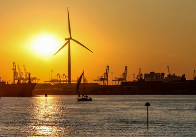 Ship in sea at sunset