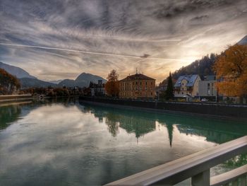 Scenic view of lake by buildings against sky