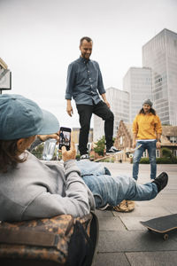 People sitting on street in city