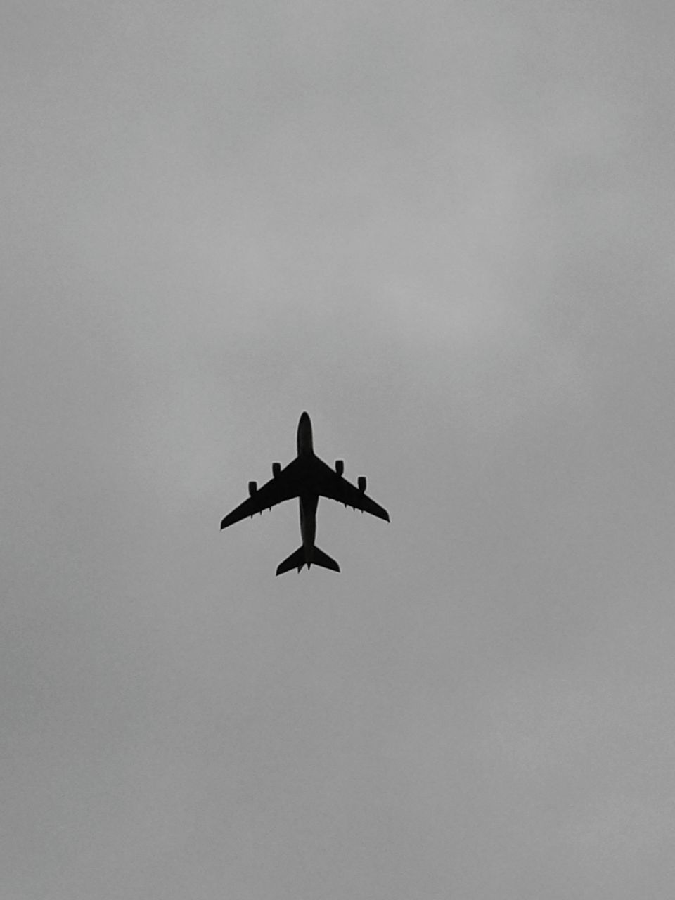 flying, mid-air, low angle view, airplane, air vehicle, silhouette, sky, transportation, on the move, mode of transport, cloud - sky, travel, spread wings, copy space, motion, bird, freedom, outdoors, nature, journey