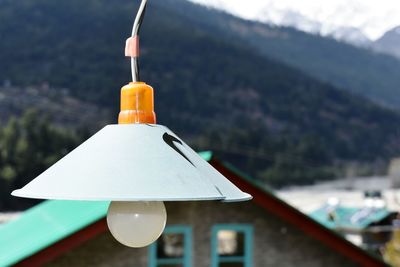 Close-up of lighting equipment hanging against mountain