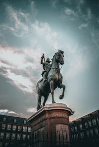Low angle view of statue against sky