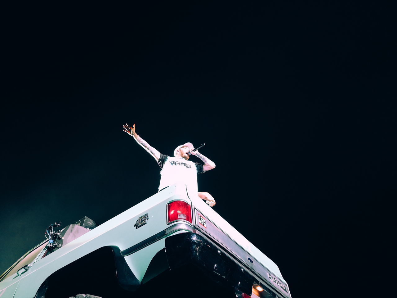 LOW ANGLE VIEW OF MAN STANDING AGAINST CLEAR SKY