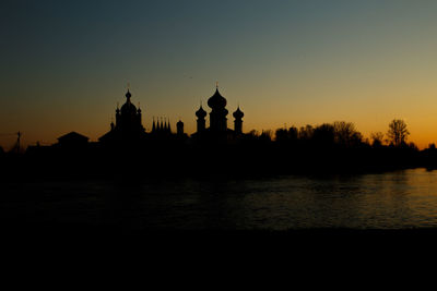 Silhouette of temple building against sky during sunset