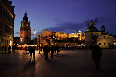 People on illuminated city at night