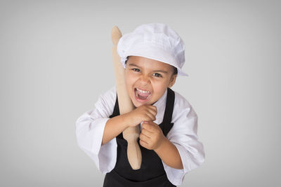 Portrait of smiling boy against white background