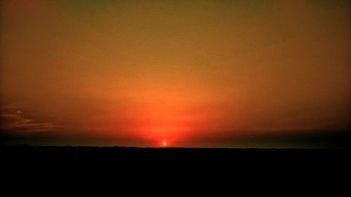 Scenic view of silhouette landscape against romantic sky at sunset